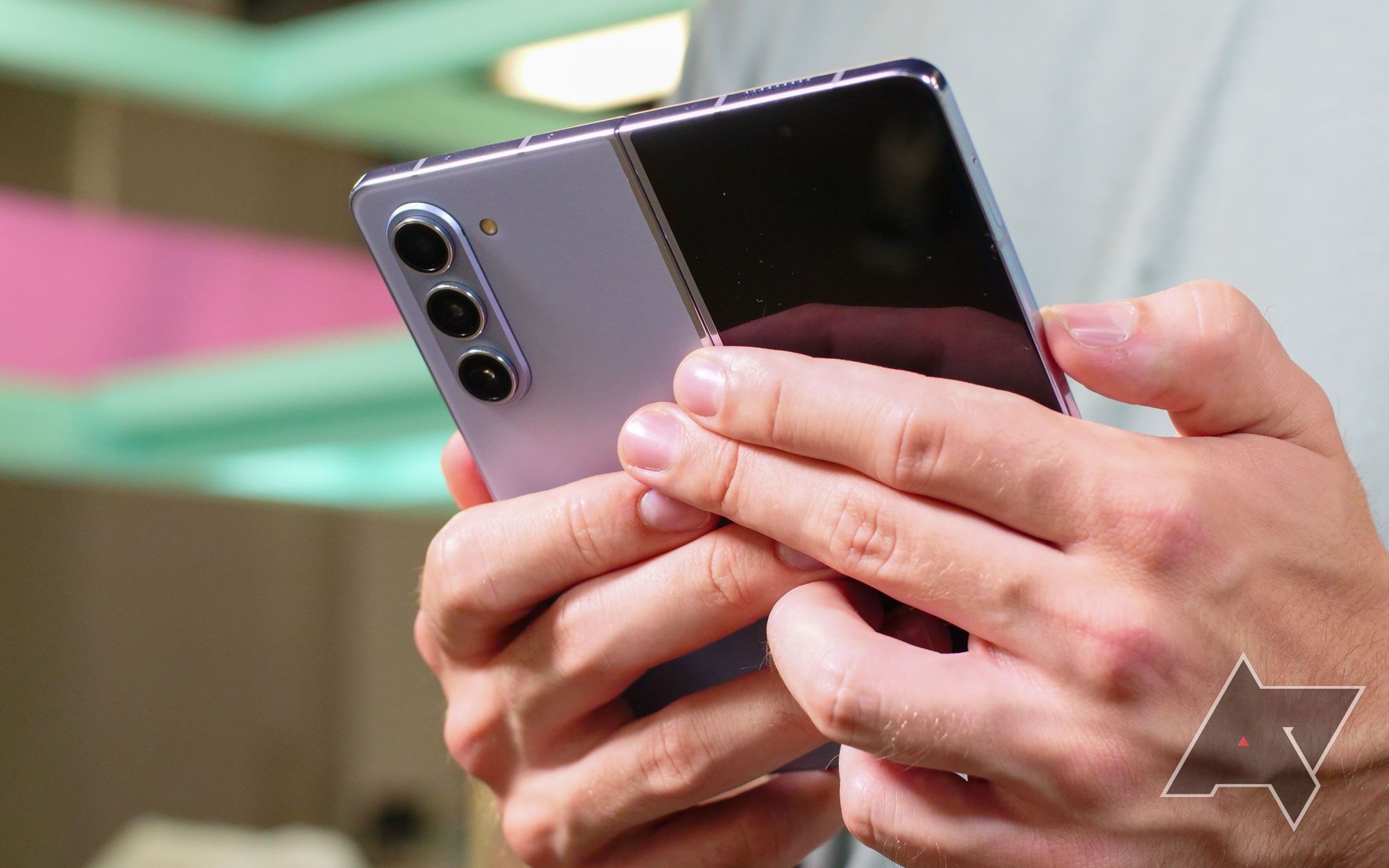 Samsung Galaxy Z Fold 5 mantido aberto, dando uma visão do conjunto de câmeras e da tela externa