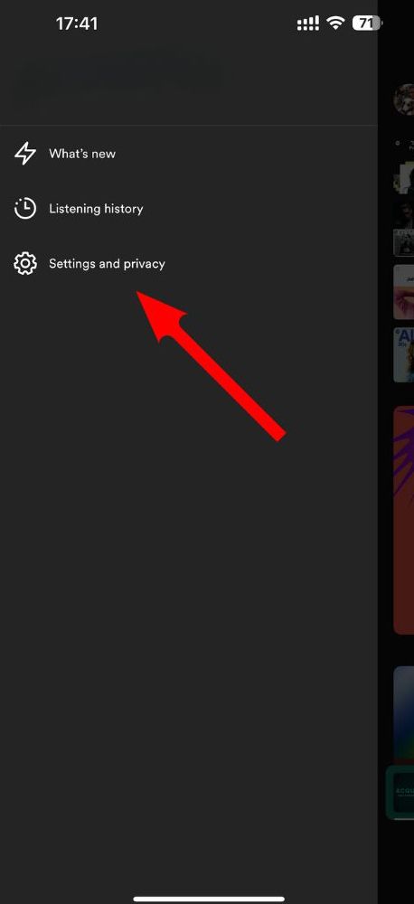 Uma seta vermelha aponta para a opção Configurações e privacidade no menu da conta Spotify