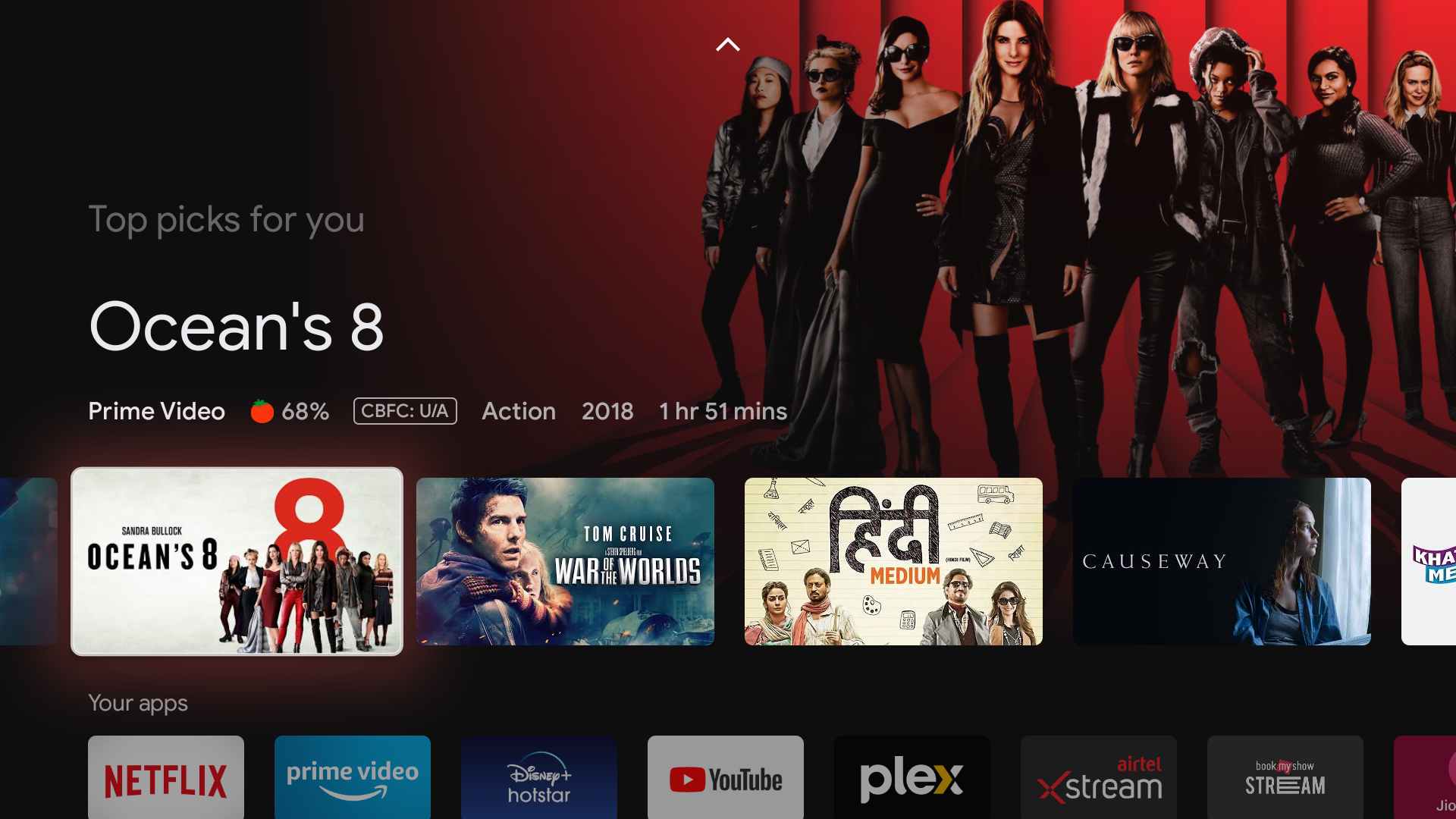 Renderização da tela do Google TV mostrando a arte principal de Ocean's 8 e vários outros filmes e plataformas de streaming em uma grade.