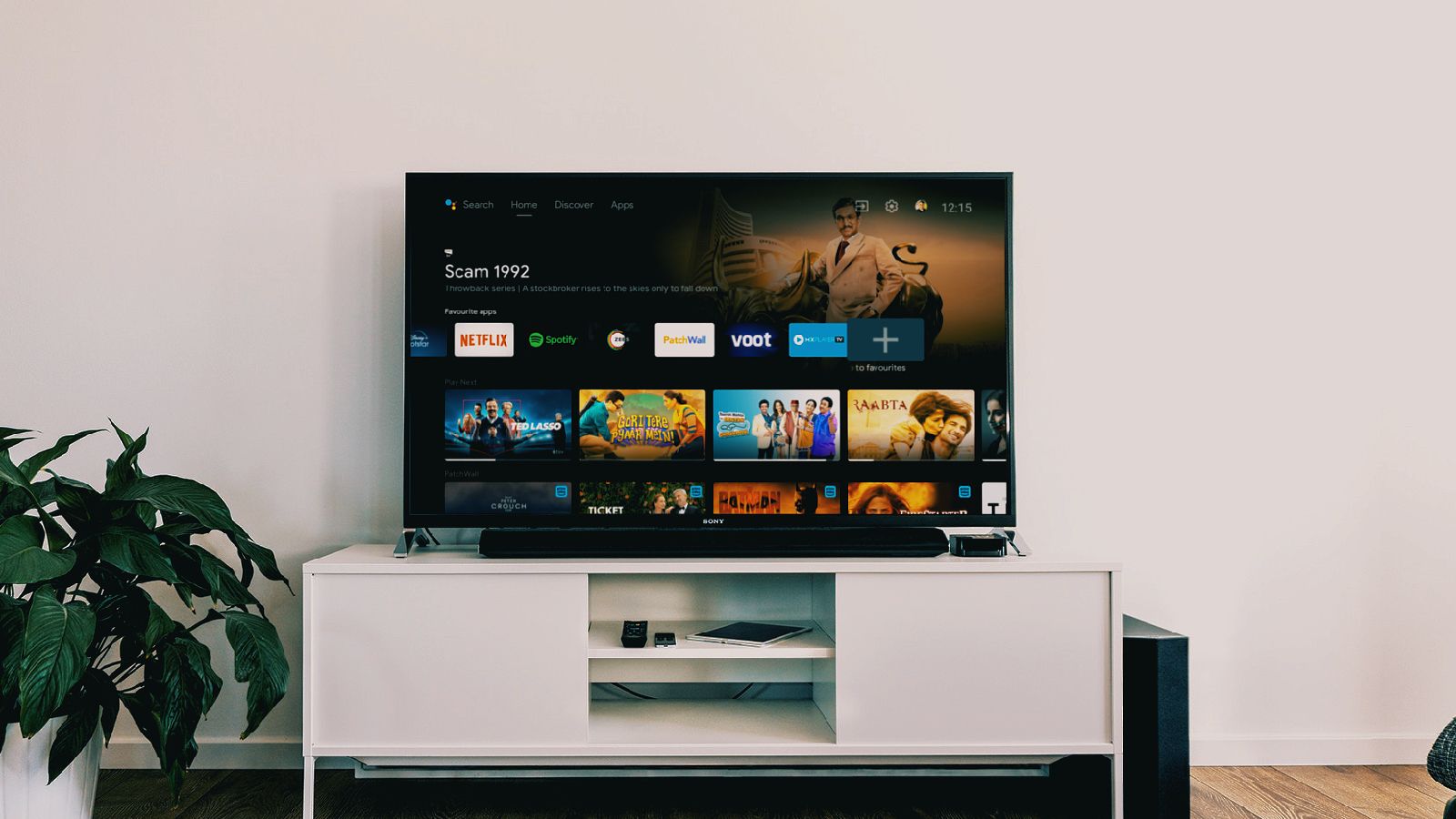 Android TV em uma TV em um armário branco contra uma parede branca.