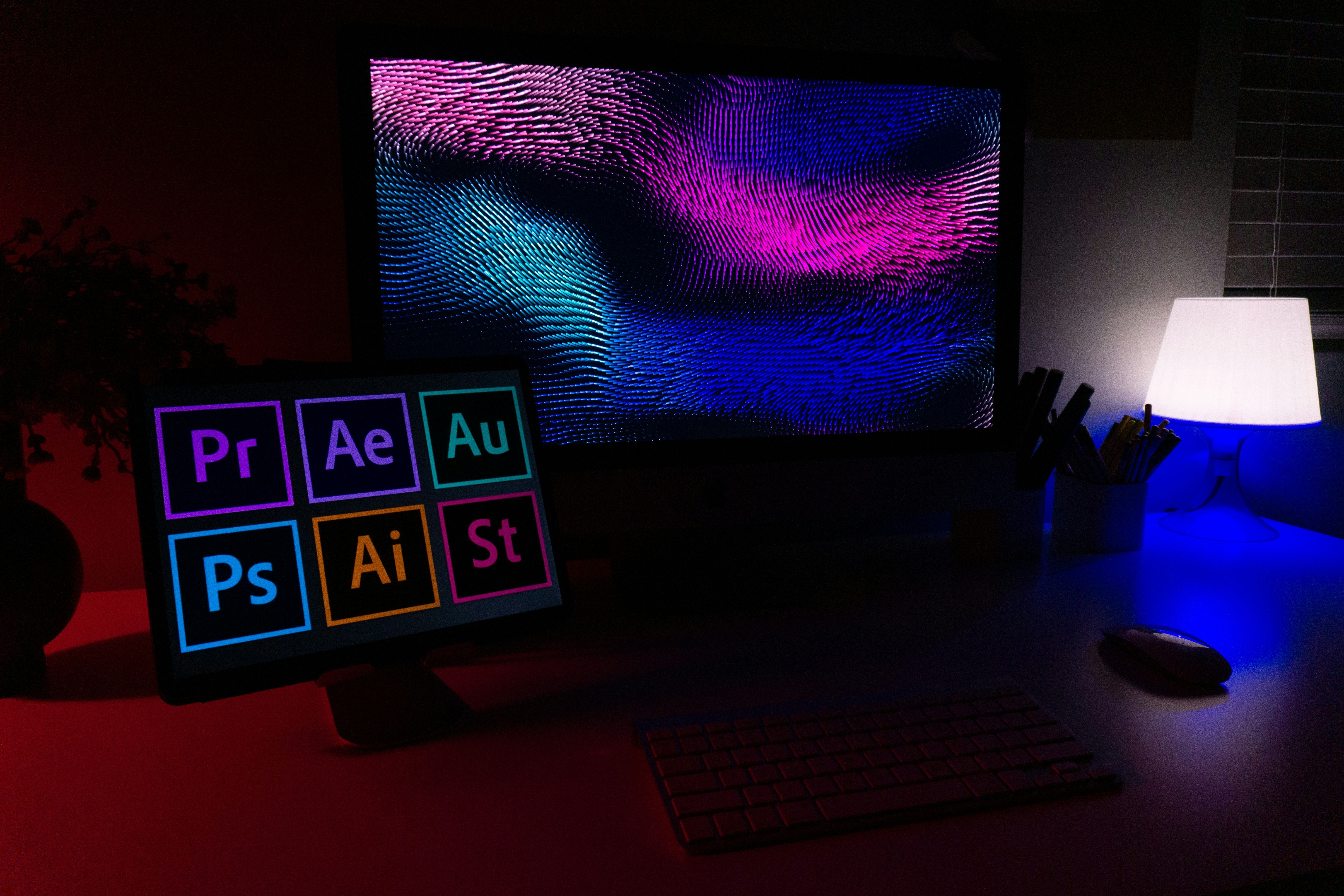 Monitores de computador mostrando programas da Adobe